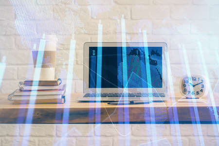 Forex market graph hologram and personal computer on background. Multi exposure. Concept of investment.の写真素材