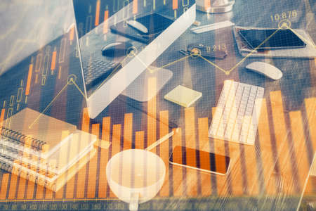 Multi exposure of chart and financial info and work space with computer background. Concept of...