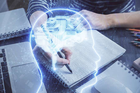 Multi exposure of writing hand on background with brain hologram. Concept of self learning.の写真素材