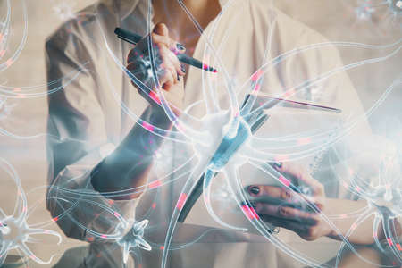 Neuron hologram over hands taking notes background. Concept of research and study. Double exposure