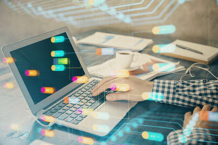 Businessman with computer background with technology theme hologram. Concept of hightech. Multi...