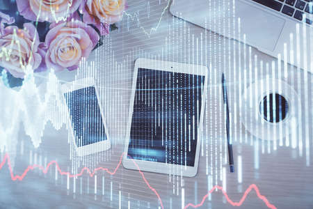 Double exposure of forex graph hologram over desktop with phone. Top view. Mobile trade platform...