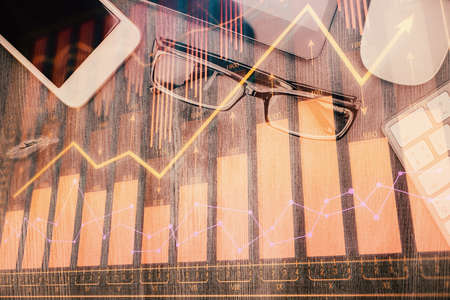 Multi exposure of forex graph hologram over desktop with phone. Top view. Mobile trade platform concept.の写真素材