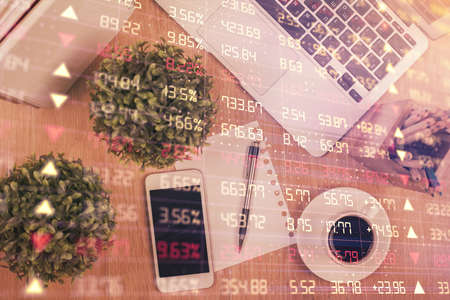 Multi exposure of financial chart hologram over desktop with phone. Top view. Mobile trade platform concept.の写真素材