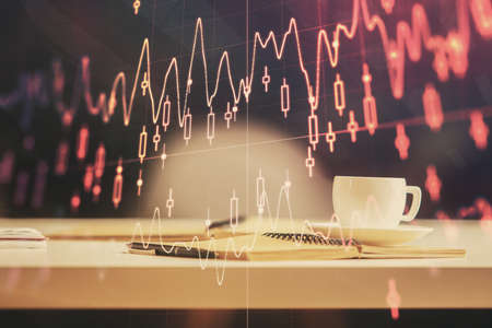 Multi exposure of forex graph drawing and desktop with coffee and items on table background. Concept...