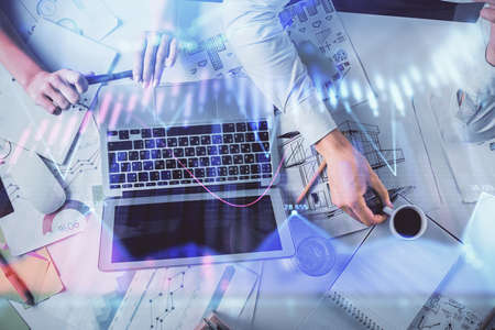 Double exposure of man and woman working together and financial graph hologram. Business concept....