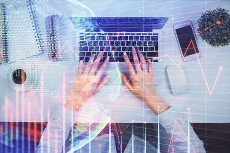 Double exposure of woman hands working on computer and forex chart hologram drawing. Top View....