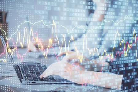 Multi exposure of woman hands typing on computer and financial chart hologram drawing. Stock market...