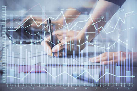 Multi exposure of woman hands typing on computer and financial chart hologram drawing. Stock market...