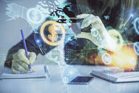 Double exposure of woman on-line shopping holding a credit card and financial graph drawing. Stock...