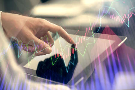 Multi exposure of mans hands holding and using a phone and financial chart drawing. Market analysis...