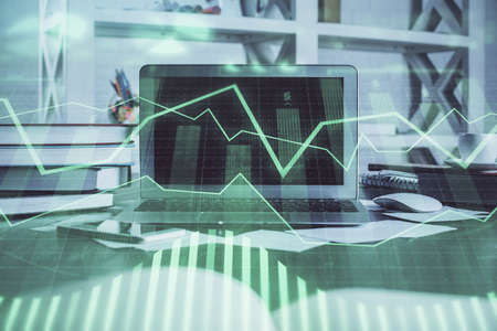 Stock market chart hologram drawn on personal computer background. Multi exposure. Concept of...