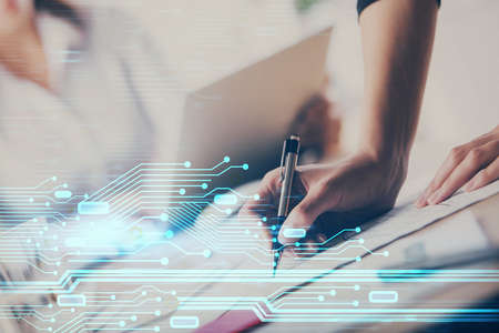 Double exposure of womans writing hand on background with data technology hud. Big data concept.