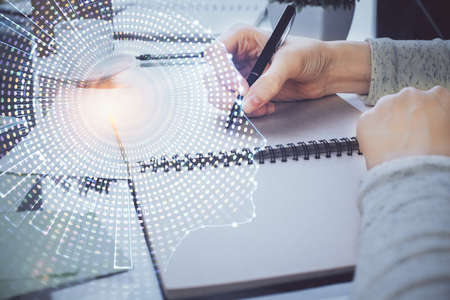 Double exposure of writing hand on background with brain hologram. Concept of learning.
