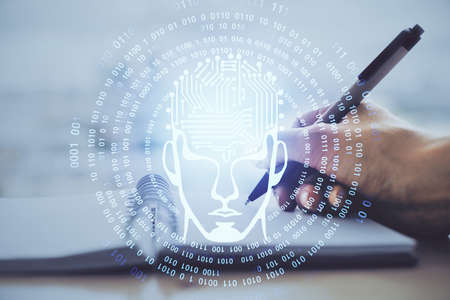 Double exposure of writing hand on background with brain hologram. Concept of learning.