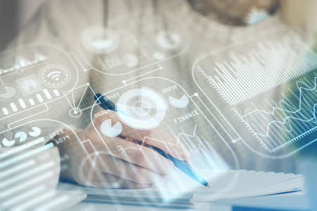 Tech theme hologram over womans hands taking notes background. Concept of hightech. Double exposure