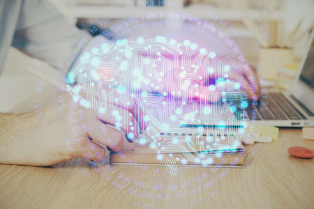 Man typing on keyboard background with brain hologram. Concept of big Data. Double exposure.