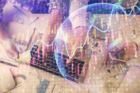 Multi exposure of man and woman working together and forex graph hologram drawing. Financial...