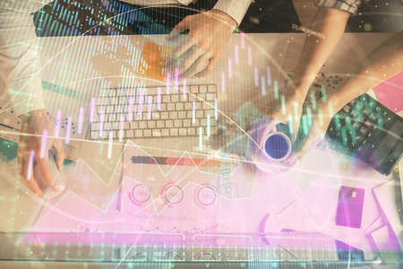 Double exposure of man and woman working together and financial chart hologram drawing. market...