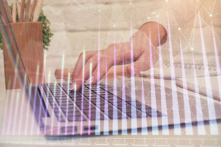 Multi exposure of woman hands typing on computer and forex chart hologram drawing. Stock market...