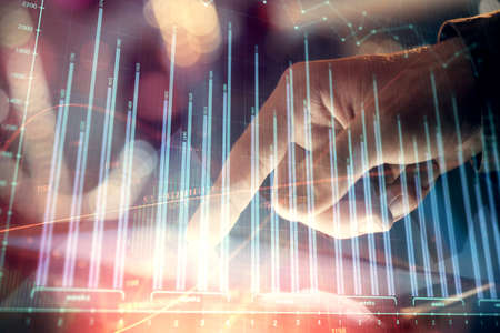 Multi exposure of mans hands holding and using a phone and financial chart drawing. Market analysis...