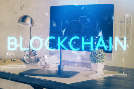 Double exposure of blockchain theme hologram and table with computer background. Concept of bitcoin crypto currency.の写真素材