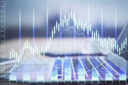 Financial market graph hologram and personal computer on background. Multi exposure. Concept of...