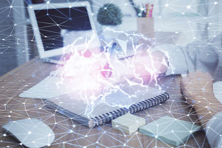 Multi exposure of writing hand on background with brain hologram. Concept of self learning.