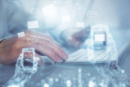 Envelop holograms with businessman working on computer on background. E-mail concept. Multi...