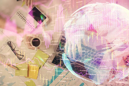 Multi exposure of mans hands typing over computer keyboard and forex graph hologram drawing. Top...
