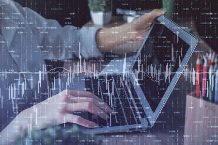 Double exposure of woman hands typing on computer and forex chart hologram drawing. Stock market...