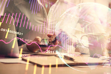 Double exposure of forex chart sketch hologram and woman holding and using a mobile device....