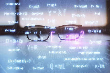 Formulas drawing with glasses on the table background. Concept of science. Double exposure.の写真素材