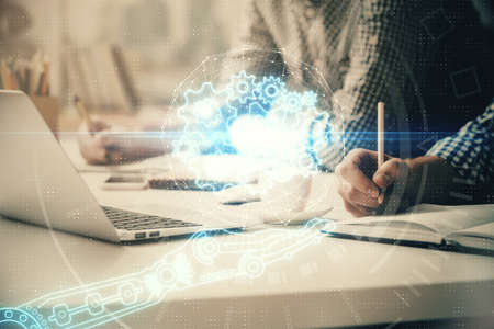 Businessman with computer background with technology theme hologram. Concept of hightech. Multi exposure.の写真素材