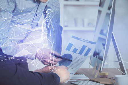 Start up drawings with businessman working on computer on background. Teamwork concept. Double exposure.の写真素材