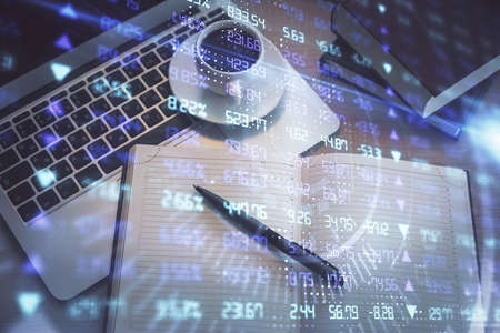 Stock market graph and top view computer on the table background. Multi exposure. Concept of...