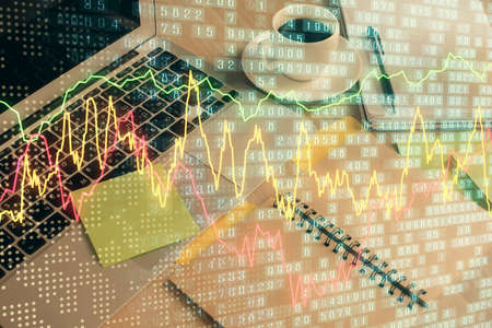 Multi exposure of forex graph drawing and desktop with coffee and items on table background. Concept...