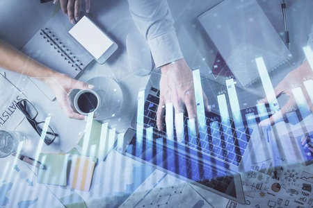 Double exposure of man and woman working together and forex graph hologram drawing. Financial...
