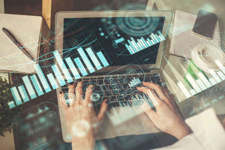 Double exposure of woman hands typing on computer and forex chart hologram drawing. Stock market...
