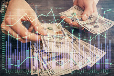 Multi exposure of financial graph drawing hologram and USA dollars bills and man hands. Analysis...