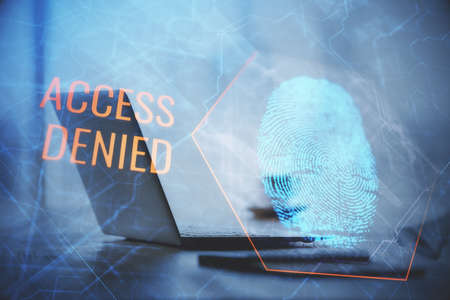 Computer on desktop in office with finger print drawing. Double exposure. Concept of business data security.の写真素材