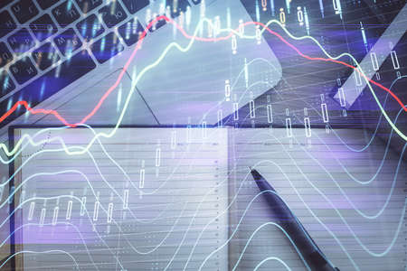 Stock market graph and top view computer on the table background. Multi exposure. Concept of...