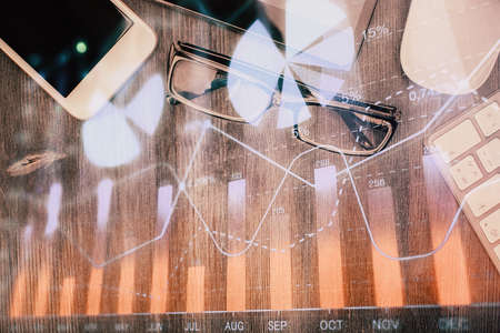 Multi exposure of forex graph hologram over desktop with phone. Top view. Mobile trade platform concept.の写真素材