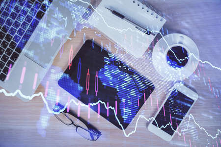Multi exposure of forex graph hologram over desktop with phone. Top view. Mobile trade platform...