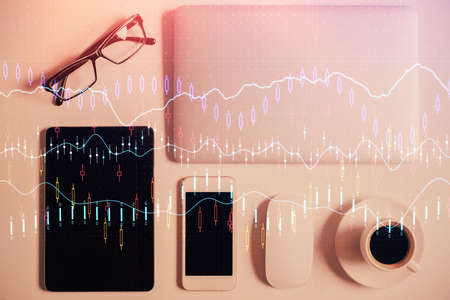 Multi exposure of financial chart hologram over desktop with phone. Top view. Mobile trade platform...