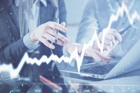 Multi exposure of man and woman working together and financial chart hologram. Business concept....