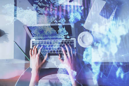 Double exposure of woman hands working on computer and forex chart hologram drawing. Top View....