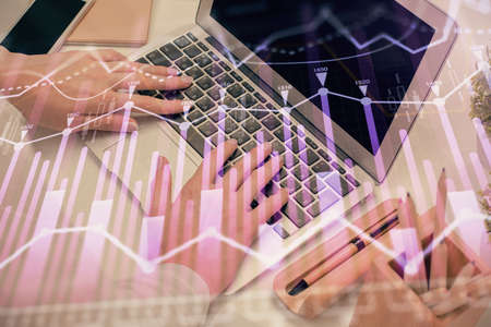 Multi exposure of woman hands typing on computer and forex chart hologram drawing. Stock market...
