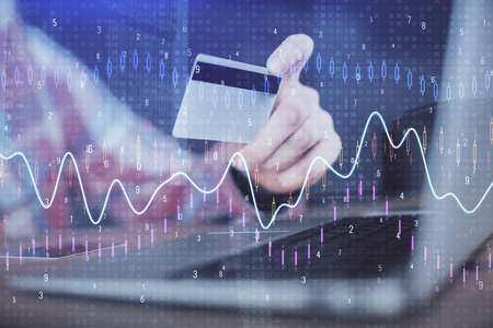 Double exposure of man hands holding a credit card and Forex graph drawing. Stock trading and...