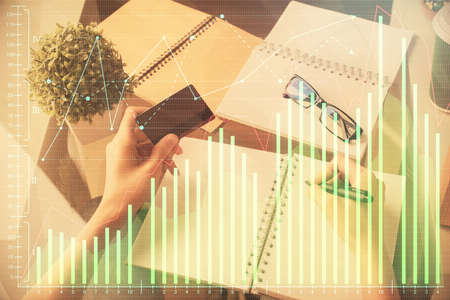 Multi exposure of woman on-line shopping holding a credit card and financial graph drawing. Stock...